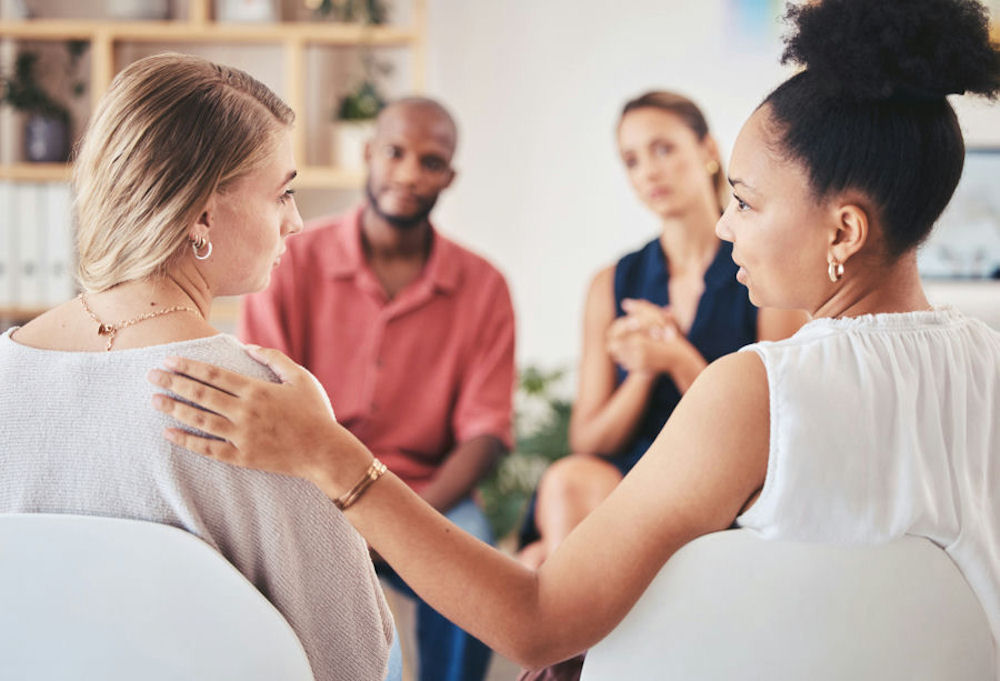 a-woman-comforting-a-woman-in-group-therapy