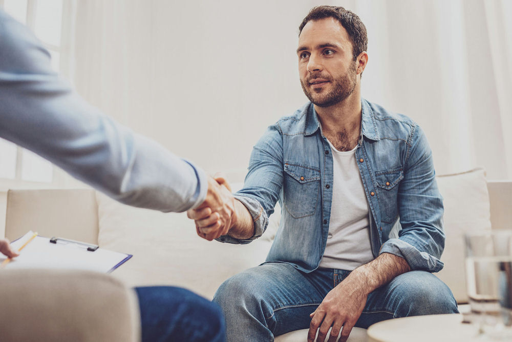 a-man-shaking-hands-during-a-cbt-session