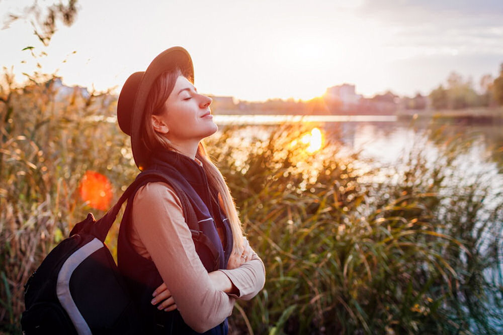 a-woman-meditating-in-nature-feeling-free